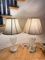 Two crystal lamps lit under staircase showing size and cords