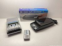 Three items: boxed GPX VHS rewinder, loose rewinder unit, GE data recorder, microcassette recorder