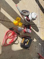 All items laid out: power station, inflator, wet/dry vac, jumper cables, funnels