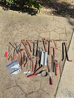 Entire lot spread on pavement showing variety of tools