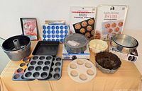 Full lot overview of assorted bakeware pieces on table