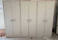 Front view of three closed metal cabinets showing doors and handles