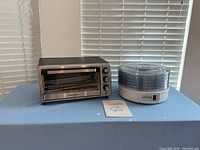 Toaster oven, food dehydrator with manual on table