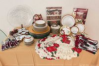 Full view of dinnerware, flatware, linens and décor arranged on table