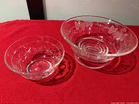 Two crystal bowls, side-by-side for size comparison, showing patterns