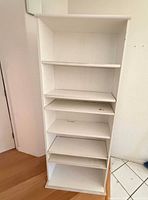 Front view showing five adjustable shelves and open back