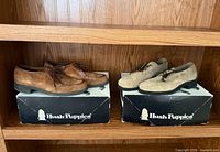 Both pairs of shoes on boxes