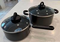 Top view of two SilverStone non-stick pots with lids