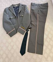 Jacket, trousers and tie laid out together
