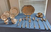 Overall lot: china, tray, bowl and serving utensils displayed on table