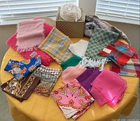 overview of all scarves, wraps and hat on table