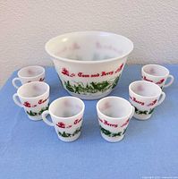 Punch bowl and six mugs arranged together