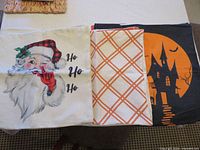 Santa, orange plaid, and Halloween haunted house covers