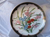 Full view of charger plate showing floral design and gold gilt border