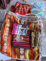Overview of striped Barbados bag, destination pouches, wristlet, and beach items