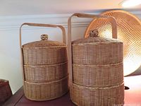 Pair of three-tier wicker baskets displayed side by side