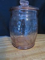 Full view of pink glass Planters jar with lid
