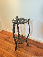 Full view of cast iron stand showing two tiers and legs