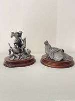 Both sculptures side by side on bases