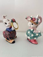 Front view of sugar bowl rabbit holding mirror spoon and matching rabbit creamer
