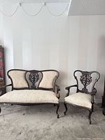 Front view of both settee and armchair showing overall design and upholstery