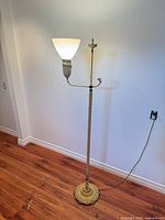 Full view of 59 in tall torchiere lamp lit