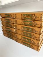 Stack of cloth-bound volumes showing decorative spines