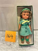 Front view of Effanbee Girl Scout doll in original box showing uniform and accessories