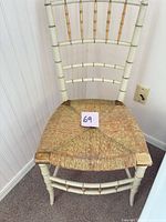 Front view of faux bamboo side chair showing off-white frame, gold accents, woven seat