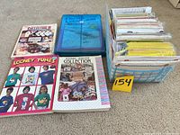 overview showing three transfer books, blue folder, basket of transfer patterns