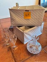 Full lot showing four goblets, cruet, two storage cases