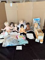 group shot of dolls, clothing bags, hangers and accessories