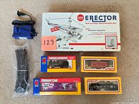 Overview of lot showing Erector box, three Life-Like train boxes, blue transformer and bag of track