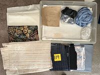 Overall lot showing folded fabrics, tote with edging and pattern