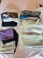 Stacked synthetic fabric pieces in bin and on table