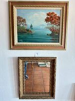 Both framed painting and mirror displayed on wall