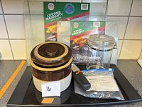 All items grouped: four glass cutting boards, warming tray, crock, canister, grater