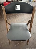 Full front view of wooden folding chair, seat and back visible