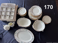 Group view of all plates, bowls, cups in protective box, serving pieces