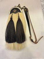 Full view of sporran showing cantle, horsehair, tassels and attached strap