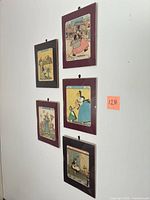All five framed magazine covers displayed on wall