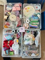 Top view of three totes open showing assorted ribbon spools and trims