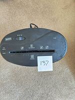 Top view showing Staples branding, controls, 8-sheet marking