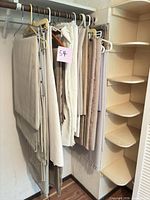 Group of neutral fabrics hanging on closet rod