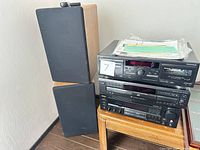 KLH speakers stacked beside three audio components