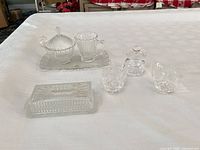 All seven pressed glass pieces arranged together