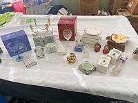 Overall view of lot showing brass candelabra, glassware, porcelain pieces, crystal ornaments and boxed items