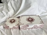 Two toile-patterned Blue Stallion gift boxes, large and small