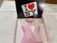 Open box showing pink Bond No.9 I Love New York perfume bottle