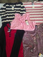 Group view of five Chaps tops with tags visible